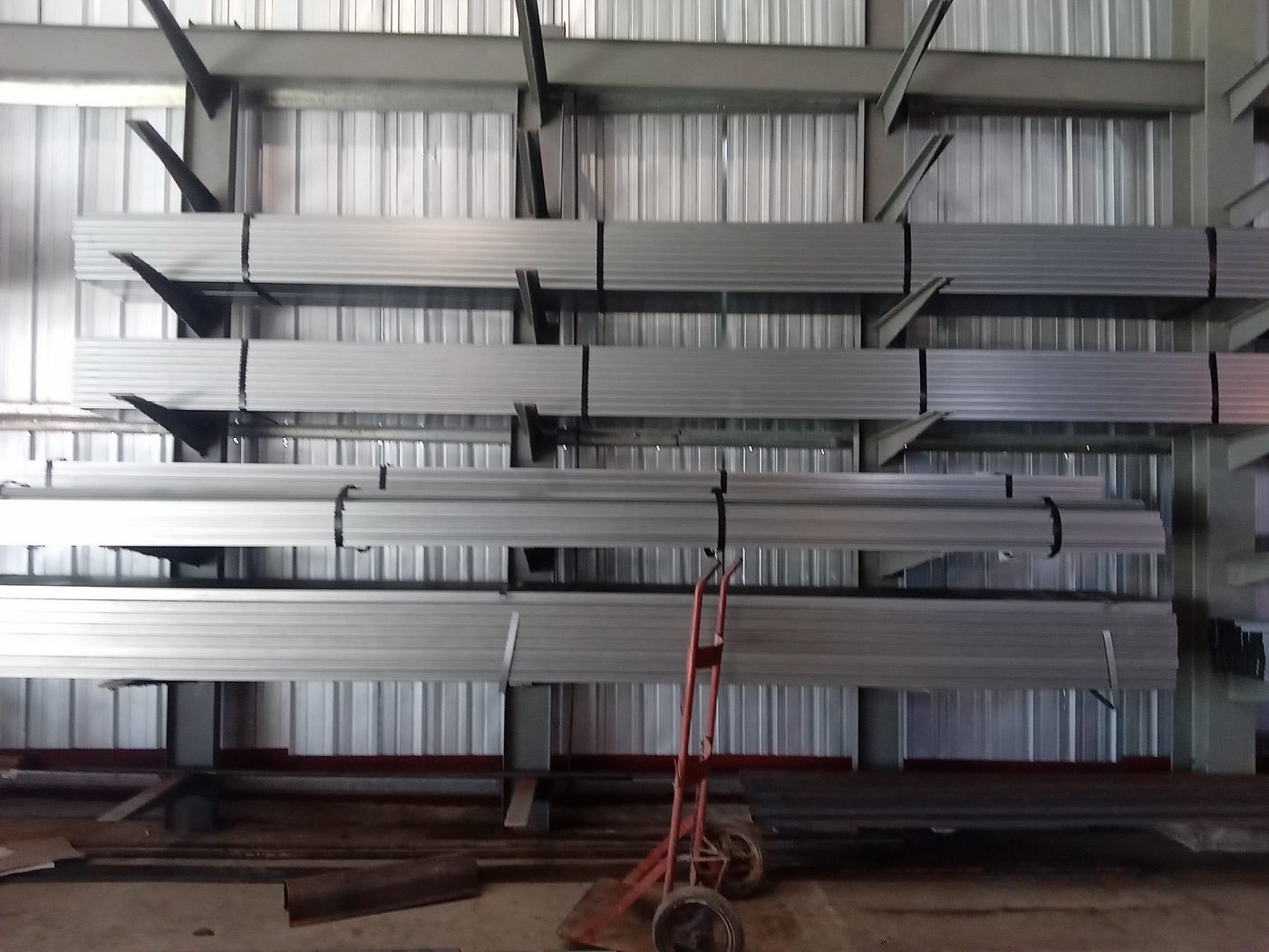 Racks con perfiles de acero organizados en el almacén